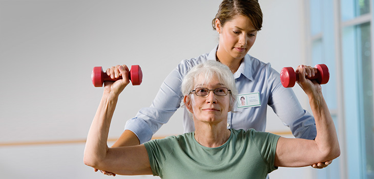 woman working with small hand weights