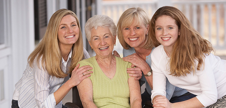 A family sitting outside smiling together