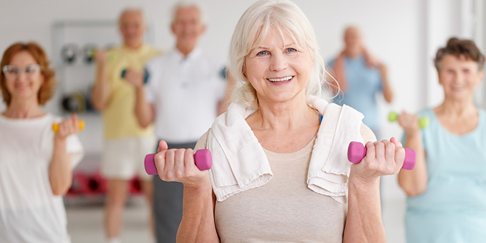 A woman exercising with people in the background