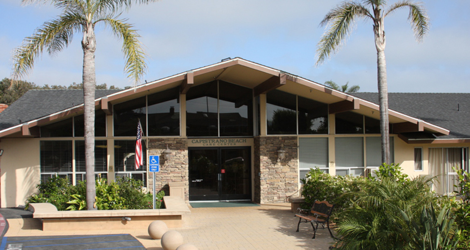 Capistrano Beach Care Center front entrance of building flanked by palm trees