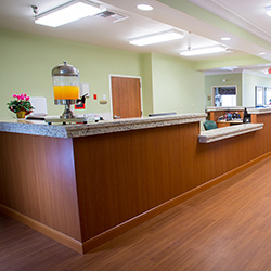 Front desk with flowers and drinks for visitors